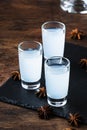 Ouzo - Greek anise brandy, traditional strong alcoholic drink in glasses on the old wooden table, place for text