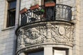 Oval balcony with decorative moldings and a cast-iron fence