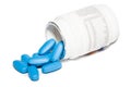 Oval blue pills spill from white prescription bottle