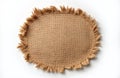 Oval burlap piece with frayed edges sits on white background. Natural textile texture. Empty space for text. Rustic design Royalty Free Stock Photo