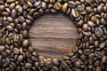 Oval of coffee beans on a wooden fone Royalty Free Stock Photo