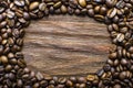 Oval of coffee beans on a wooden fone Royalty Free Stock Photo