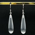 Oval crystal earrings next to each other behind a black background Royalty Free Stock Photo