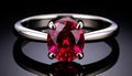 Oval Cut Ruby Gemstone Ring in Silver Setting on a Dark Reflective Surface jewelry Royalty Free Stock Photo
