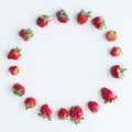 Round frame of strawberries on white background. Flat lay, top view. Size 1x1, square photo