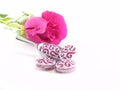 Oval glass beads and pink rose on white background. Jewelry making hobby, handmade,craft concept