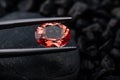 Oval red garnet gemstone with dark rock Royalty Free Stock Photo