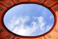 View of blue sky and clouds through oval rooftop of public theater building in Ferrara, Italy for commercial real estate concept Royalty Free Stock Photo