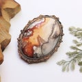 Oval Silver And Copper Gemstone Brooch With Atmospheric Color Washes