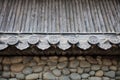 Oval stone material composition of the wall, the Chinese style with design tiles, wooden pillars constitute the wall Royalty Free Stock Photo