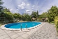 Oval swimming pool in garden Royalty Free Stock Photo