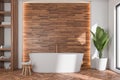 Oval white bathtub in modern bathroom with wood look tiles Royalty Free Stock Photo