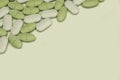 Oval white and green tablets on a white background close up Royalty Free Stock Photo