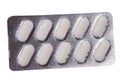 Oval white pills in a gray blister pack on a white background