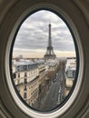 Oval Window View of Eiffel Tower and Parisian Streetscape. Royalty Free Stock Photo