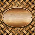 Oval Wood Board on Braided Wooden Background Royalty Free Stock Photo