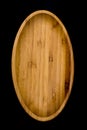 Oval wooden plate on black background