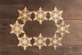 Oval snowflake frame design on wooden table Royalty Free Stock Photo