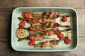 Oven baked asparagus wrapped with bacon in ceramic dish on wooden table Royalty Free Stock Photo