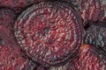 Oven baked beetroot slices closeup. Burgundy beets slice background