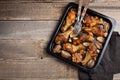 Oven baked chicken legs with onions, garlic and peppers on a dark wooden background closeup. Top view with copy space Royalty Free Stock Photo