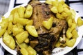 Oven-baked golden-crusted duck with potatoes lies on the dish