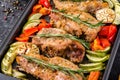 Oven baked pork entrecotes with bell pepper and zucchini.