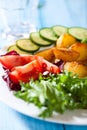 Oven baked potatoes with fresh vegetables on a pla Royalty Free Stock Photo