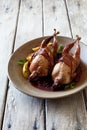 Oven baked quails served with berry sauce