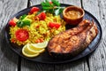 Oven baked salmon steak with yellow rice Royalty Free Stock Photo