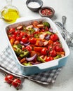 Oven baked vegetables and sausages, healthy lunch, sweet potato onion tomato broccoli