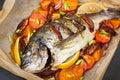 Oven baked whole sea bream fish with vegetables Royalty Free Stock Photo