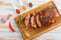 Oven-Barbecued Pork shoulder cut on slices on chopping board Royalty Free Stock Photo