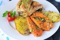 Oven cooked chicken with potato and sweet potato, spices , herbs in olive oil. Home cooking, healthy food concept. Royalty Free Stock Photo