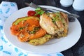 Oven cooked chicken with potato and sweet potato, spices , herbs in olive oil. Home cooking, healthy food concept. Royalty Free Stock Photo