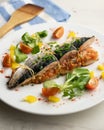 Oven-cooked mackerel stuffed with tomato sauce and vegetables. Royalty Free Stock Photo