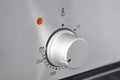 Oven cooking temperature control knob. Kitchen equipment panel detail Royalty Free Stock Photo