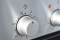 Oven cooking temperature control knob. Kitchen equipment panel detail Royalty Free Stock Photo