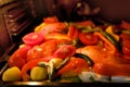 oven grilled chicken legs with delicious curry sauce served on baking tray, baked potatoes with meat, red paprika, green capsicum Royalty Free Stock Photo