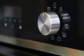 Oven knob controller with multi-function settings from side view Royalty Free Stock Photo
