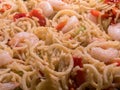 Closeup of healthy noodles from spiralized butternut squash with shrimps and red peppers