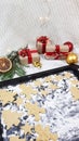 on the oven tray there are cookies in the form of Christmas trees, stars and a ginger flat man. in the background is a Royalty Free Stock Photo