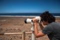 A young man using a tower viewer in Cofete beach, Fuerteventura, Canary Islands. Royalty Free Stock Photo