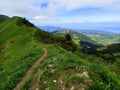 Over the crest, hiking in vertiginous landscape Royalty Free Stock Photo