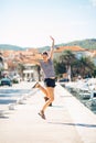 Over exited happy woman jumping in the air out of happiness.Vacation time concept.Seaside coastal vacation excitement.Woman in joy