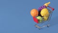 Over filled shopping cart with fruits and vegetables