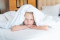 Over head sleep blanket pain girl phone young mobile sleeping, for morning white from pillow from happy smile, positive Royalty Free Stock Photo