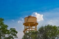 Over Head Tank Looking Attractive With Green Trees & Blue Sky Background.