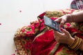 Girl in traditional indian saree using mobile phone