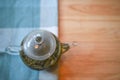 Over head view of a hot drink image of a glass tea pot filled with fresh green tea on a wooden table with cloth background Royalty Free Stock Photo